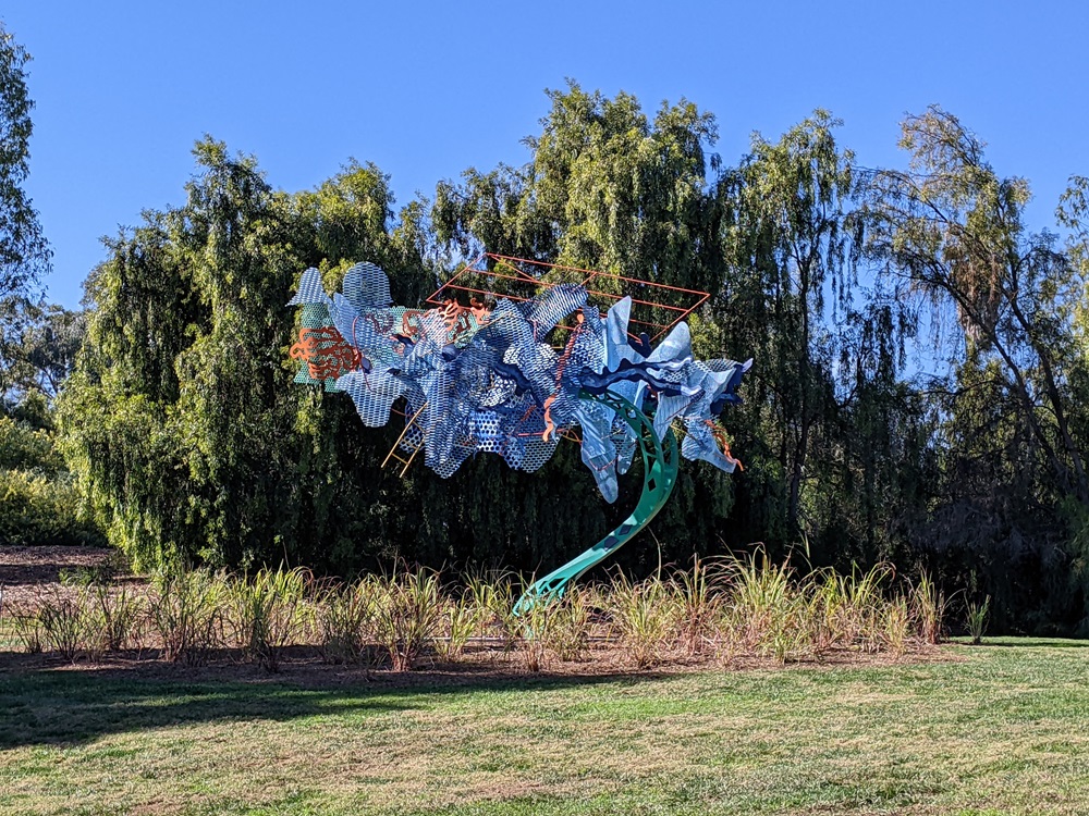 Trace, by Nancy Graves - a bronze and polychromed patina steel sculpture, with trees behind it